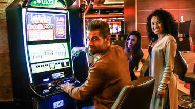 Group of young people playing slots at the M Resort