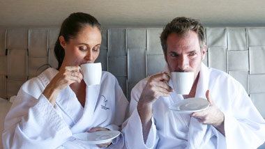 Couple drinking coffee in bed