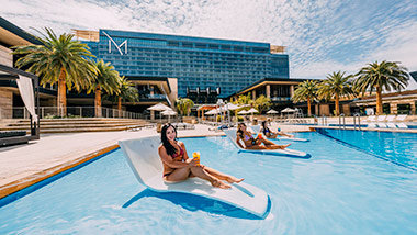 women lounging on M Pool chairs