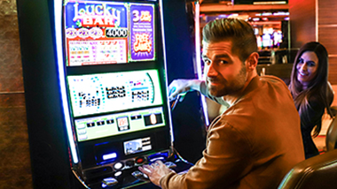 guy playing a slot machine